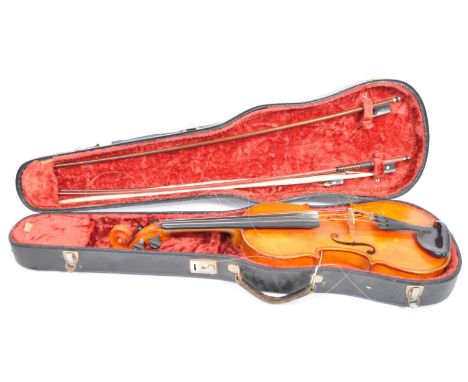 A vintage mid 20th century string music instrument violin. Four string with f holes, within&nbsp; hinged carry case. Present 