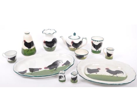 A early 20th century Bristol Pountney's Cock &amp; Hen pattern pottery tea service set. Comprising of teapot, vase, stem tape