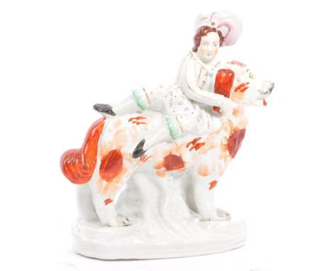 An early 20th century Staffordshire ceramic dog with riding boy. Hand painted in a russet / liver decoration with gilt highli