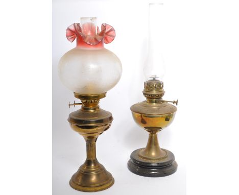 A Victorian 19th century brass and glass oil lamp. Gilt brass with reservoir complete with frosted shade having flue within. 