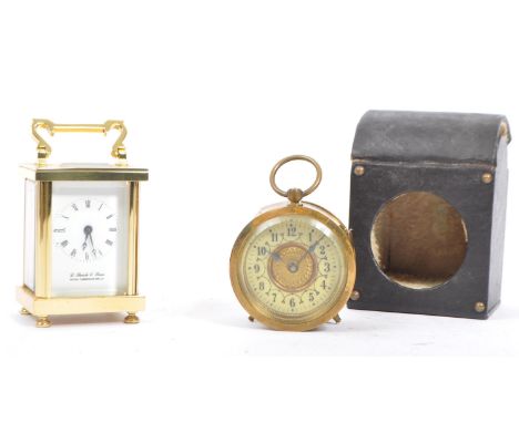 An early 20th century continental alarm clock having enamelled face and being set within domed leather travel case. Together 