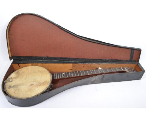 A vintage 20th century string musical instrument banjo. Having a long neck with tuners, onto a round body with plastic membra