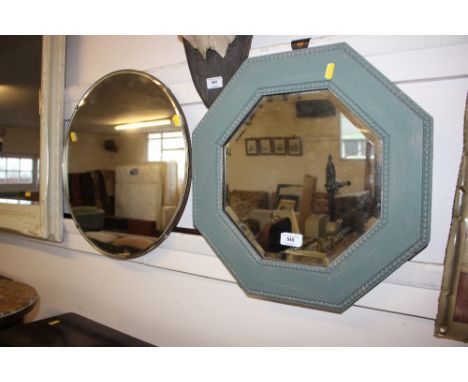 A painted oak octagonal wall mirror; and an unframed circular wall mirror