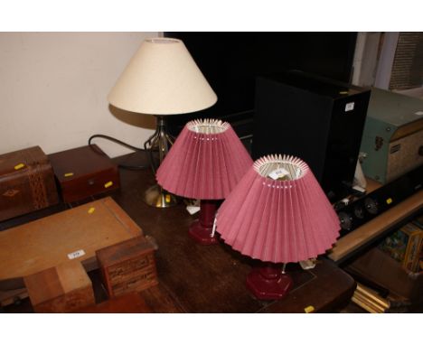 A pair of china table lamps and shades and a brass table lamp and shade