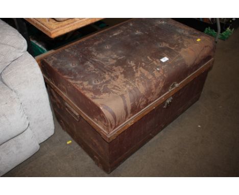 A tin trunk and contents of textiles 