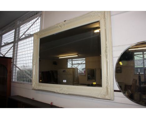 A large painted and bevel edged wall mirror 