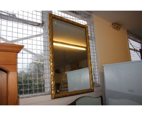 A large gilt framed mirror 