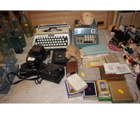 A quantity of various cameras; a typewriter; a calculator; playing cards etc. 
