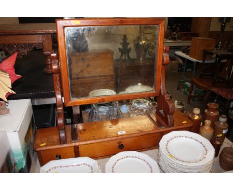 A pine swing framed mirror raised on three drawer boxed base 