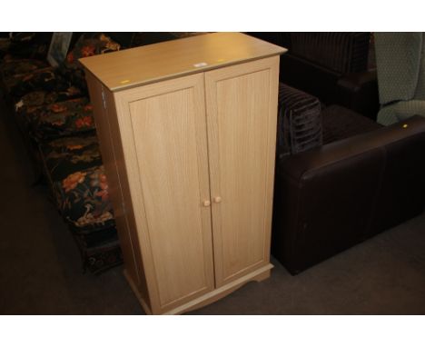 A light oak effect shoe cupboard