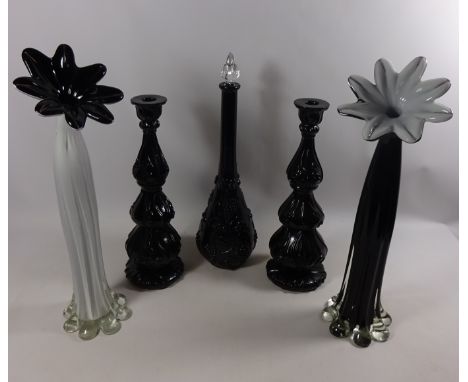 Two large flower shaped glass vases, pair of candle sticks and a tall black glass decanter  Condition Report Click here for f