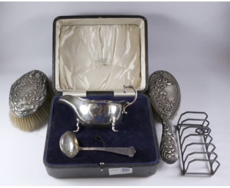 Hallmarked silver sauce boat & ladle (boxed) a similar seven bar toast rack, two silver backed brushes Condition Report Click