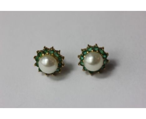 A pair of pearl and emerald ear studs in yellow gold