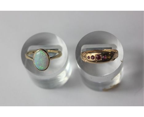 A ruby four stone ring in 15ct gold (a/f), and an opal ring in 9ct gold