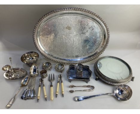 A silver plated oval serving tray 50cm a circular mirror topped table stand on cast sphinx feet, 26cm, a small desk stand wit