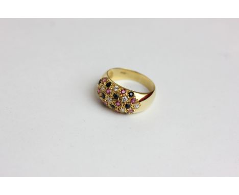 A diamond, ruby and sapphire bombe dress ring in 18ct yellow gold