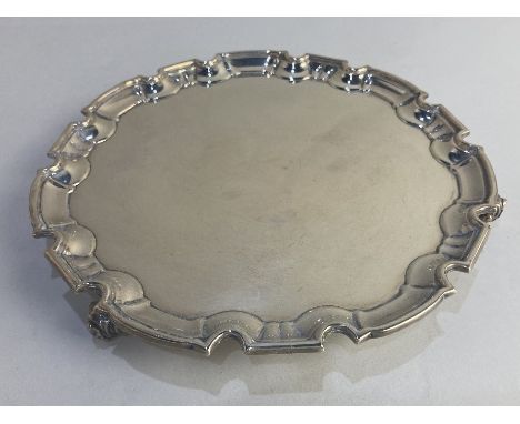 A George V silver salver, maker William Hutton &amp; Sons, Sheffield 1924, with piecrust border, on scroll feet, 24.5cm diame