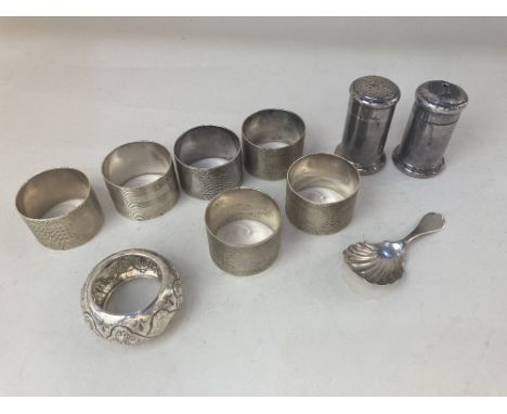 A Victorian silver caddy spoon, makers mark worn, London 1900, with scalloped bowl, a set of five silver napkin rings and two