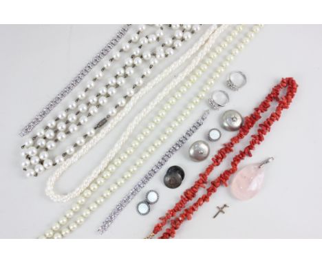 A freshwater pearl necklace; a coral necklace; a rose quartz pendant; a tiny 9ct gold cross; a quantity of costume jewellery 
