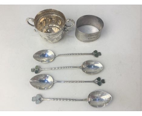 A set of four George V silver coffee spoons, maker Joseph Cook &amp; Son, Birmingham 1927, with twist handles and green ename