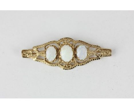 An opal brooch claw set with three graduated oval cuts