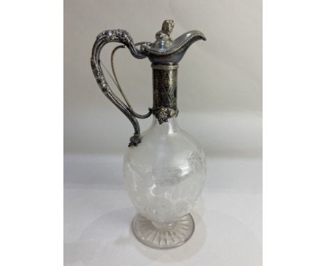 A Victorian silver plate mounted etched glass claret jug, with lion finial and grapevine design, the handle with mechanism to