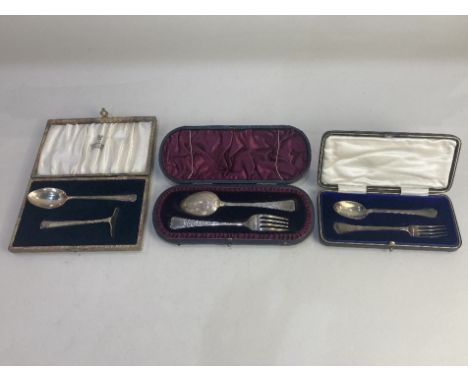 Three Victorian and later cased silver christening sets, a spoon and fork with engraved design, makers Lee &amp; Wigfull, She