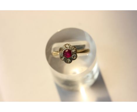 A ruby and white sapphire cluster ring in yellow gold or platinum