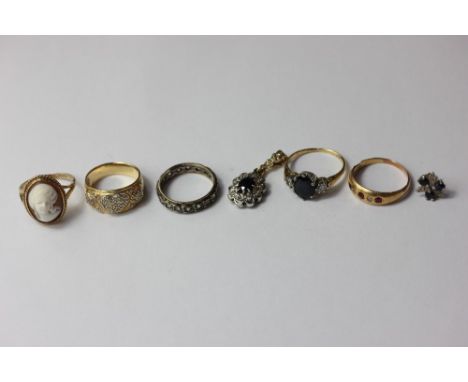 A pave set diamond ring; a sapphire and diamond cluster ring; a ruby half hoop ring; a sapphire and diamond pendant; an etern