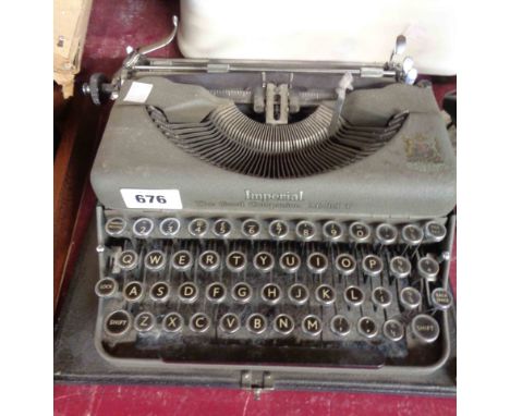 A vintage Imperial The Good Companion Model T portable typewriter with grey textured painted finish