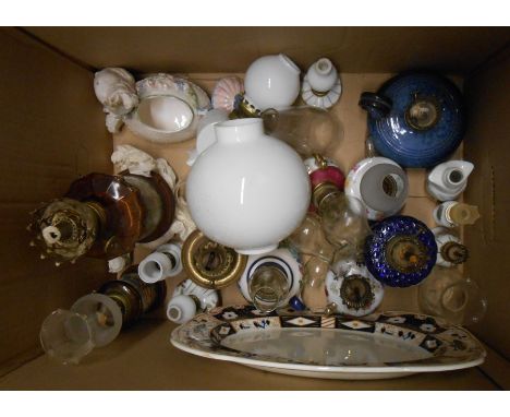 A box containing a quantity of ceramic and glass miniature oil lamps of various styles and makers