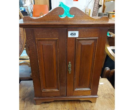 A 37cm late Victorian mahogany smoker's cabinet with shaped pediment, shelf and drawer fitted interior enclosed by a pair of 