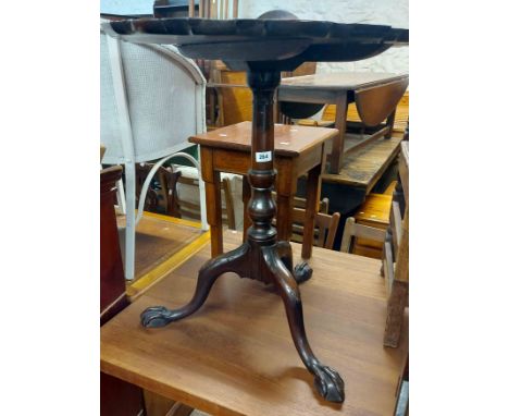 A 63cm diameter Georgian mahogany tilt-top table, set on turned pillar and acanthus carved tripod base with claw and ball ter