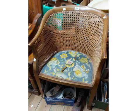 A 20th Century mahogany framed bergere style tub chair with rattan back panel and upholstered seat, set on square tapered leg