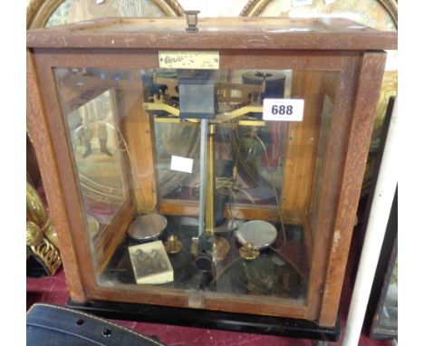 A set of vintage laboratory scale by L. Oertling Ltd. of London, set on black glass panel in glazed wooden case with slide fr