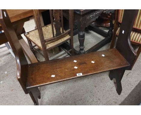 An 80cm antique oak bench with raised and shaped standard ends