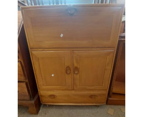 A 82cm Ercol light elm Windsor drinks cabinet with fall-front compartment to top, pair of cupboard doors and long drawer unde