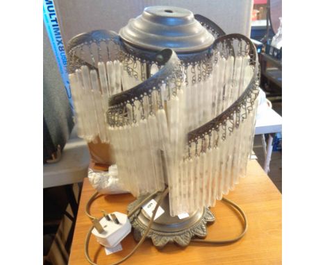 A vintage brass table lamp with a fringed glass shade