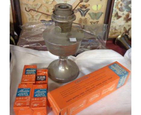 A vintage metal Aladdin table oil lamp with boxed accessories including spare mantle, chimney, etc.