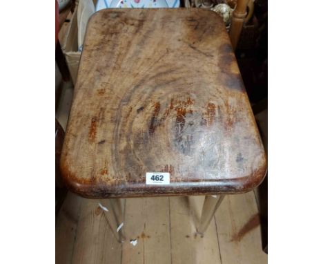 A 54cm laboratory stool with solid wooden seat, set on tapered glass legs