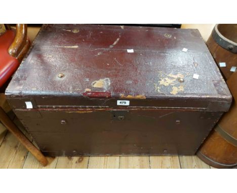 A 69cm old travelling trunk with burgundy weather coat and iron strapping - internal tray missing