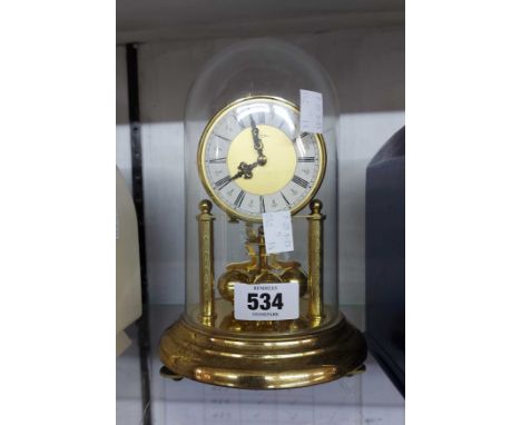 A vintage small Kein anniversary clock with ball pendulum under prespex dome