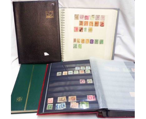 A red stock book containing sparse world stamp contents - sold with two empty stock books and a blue ring bound album with hi