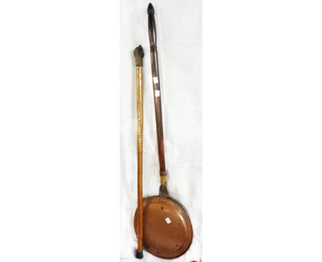 A varnished wood walking stick with carved dog head handle - sold with a copper warming pan