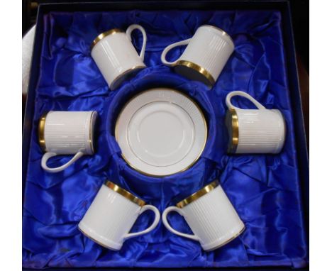 A Crown Staffordshire bone china coffee set comprising four cups and saucers in the Golden Glory pattern made as a reproducti