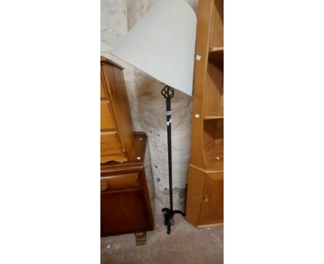 A modern black metal standard lamp with cream shade