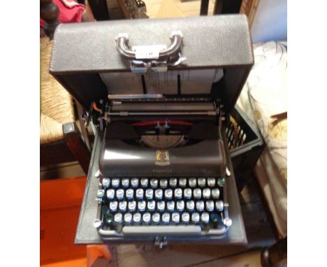 A vintage Imperial portable typewriter with gun metal grey finish in original hard carry case