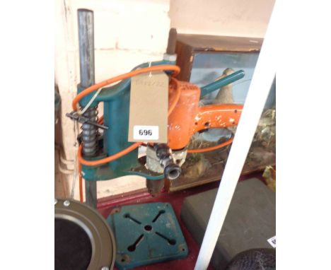 A vintage Black &amp; Decker hand drill with stand