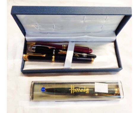 A blue box containing three pens comprising a Mont Blanc fountain pen, a similar rollerball and a Lacoste fountain pen - sold