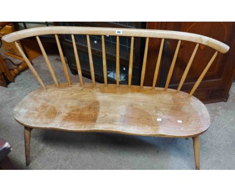 A 1.22m vintage Ercol light elm love seat with stick back and moulded solid seat, set on simple turned supports - split to se